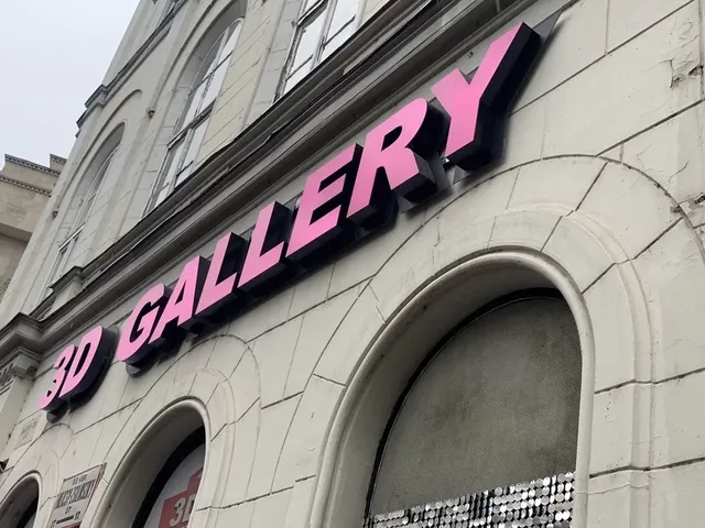 Raised gallery lettering on a masonry facade