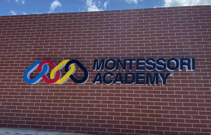Montessori Academy raised letters on a brick façade