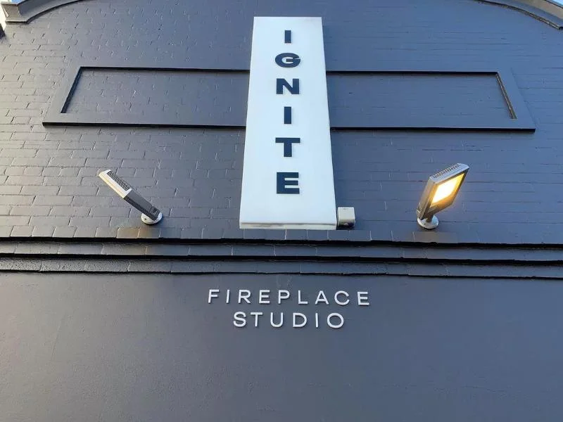 Ignite projecting sign above a fireplace studio entrance