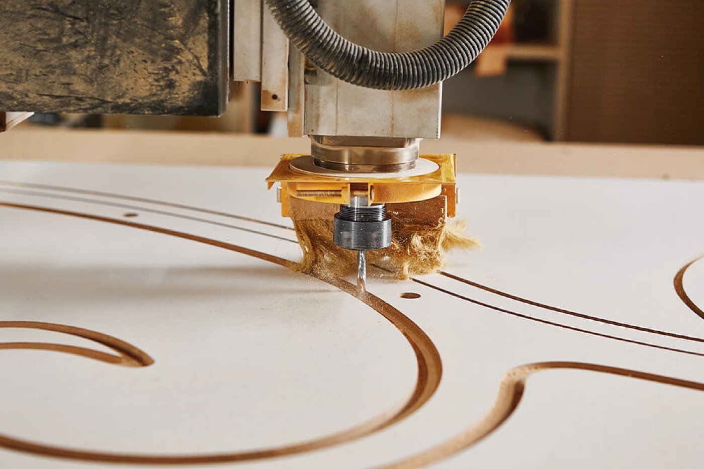 Routing a curved pattern into sheet material
