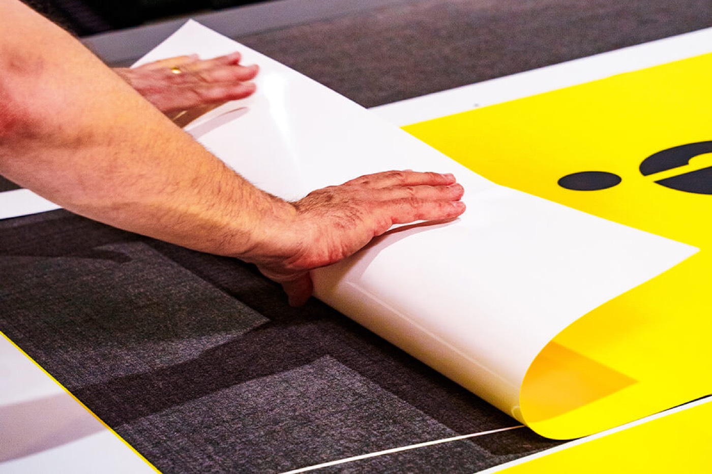 Printed vinyl being finished after kiss-cutting