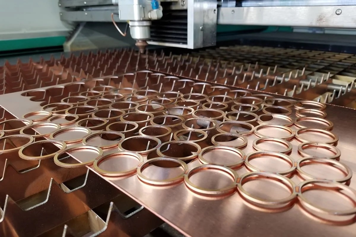 Copper rings nested and cut from sheet on the fiber laser bed