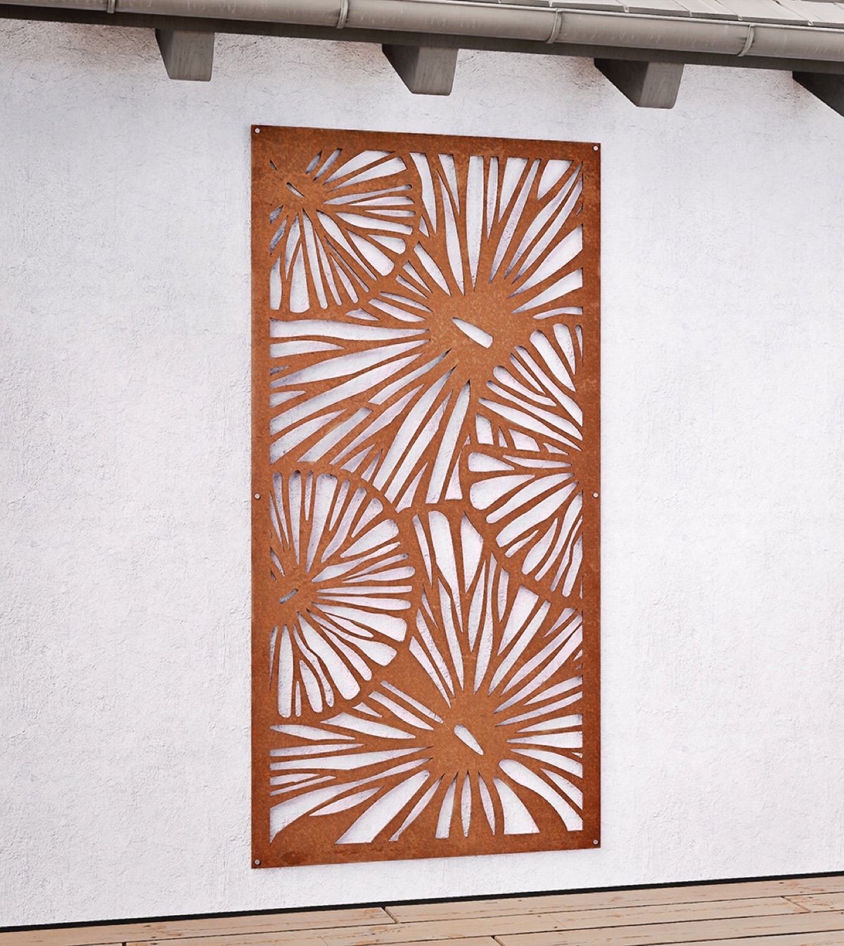 Corten steel decorative screen with leaf pattern mounted on a rendered wall