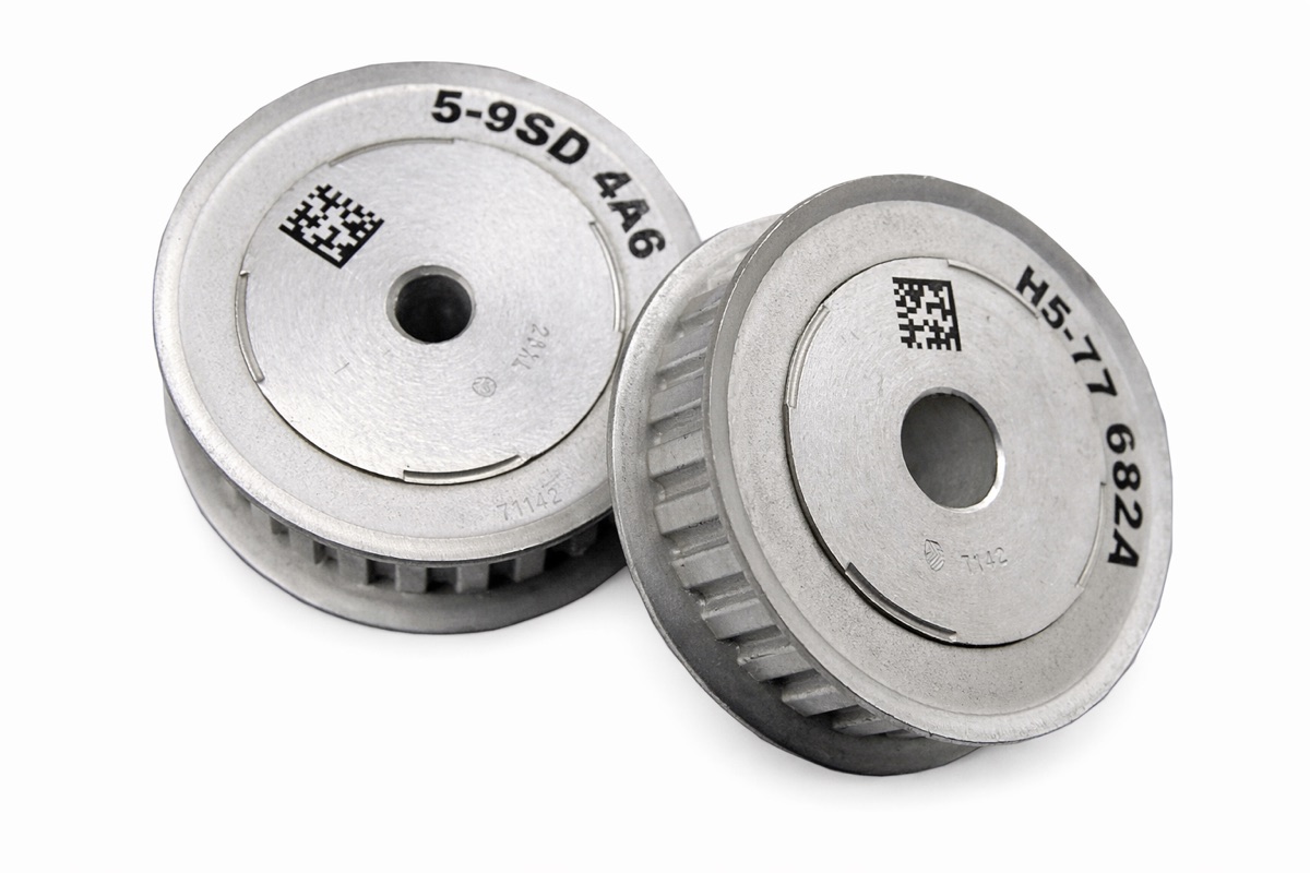 Alloy pulleys marked with part numbers and data-matrix codes