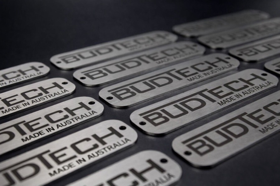 Batch of brushed stainless BUDTECH tags laser marked Made in Australia