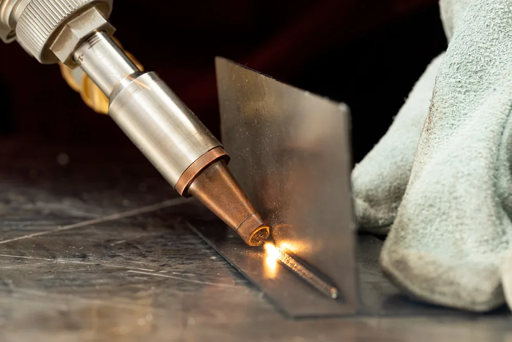 Handheld laser welder joining stainless steel sheet in the workshop