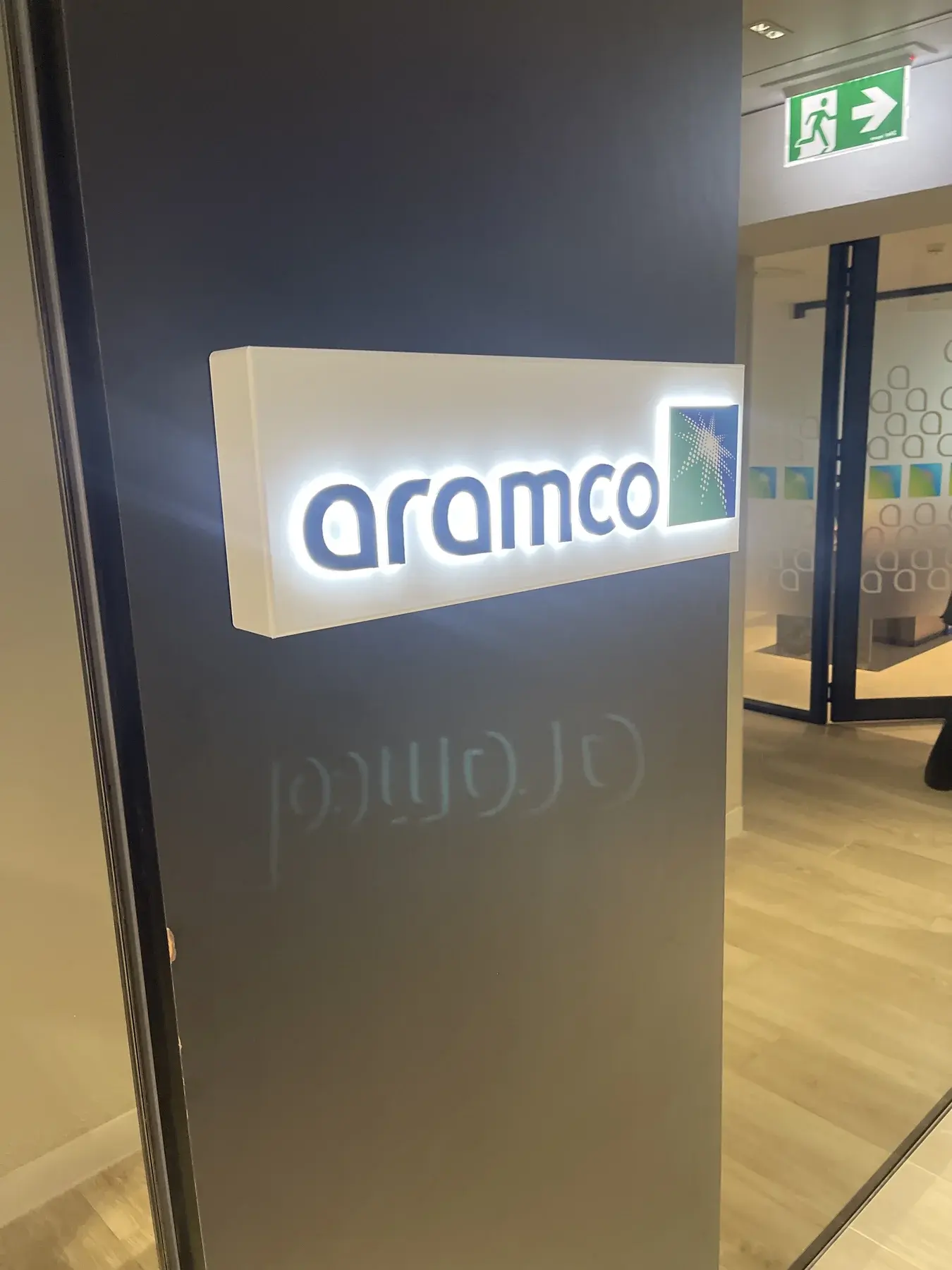 Custom-built illuminated Aramco lightbox with push-through acrylic lettering installed within the completed Sydney office