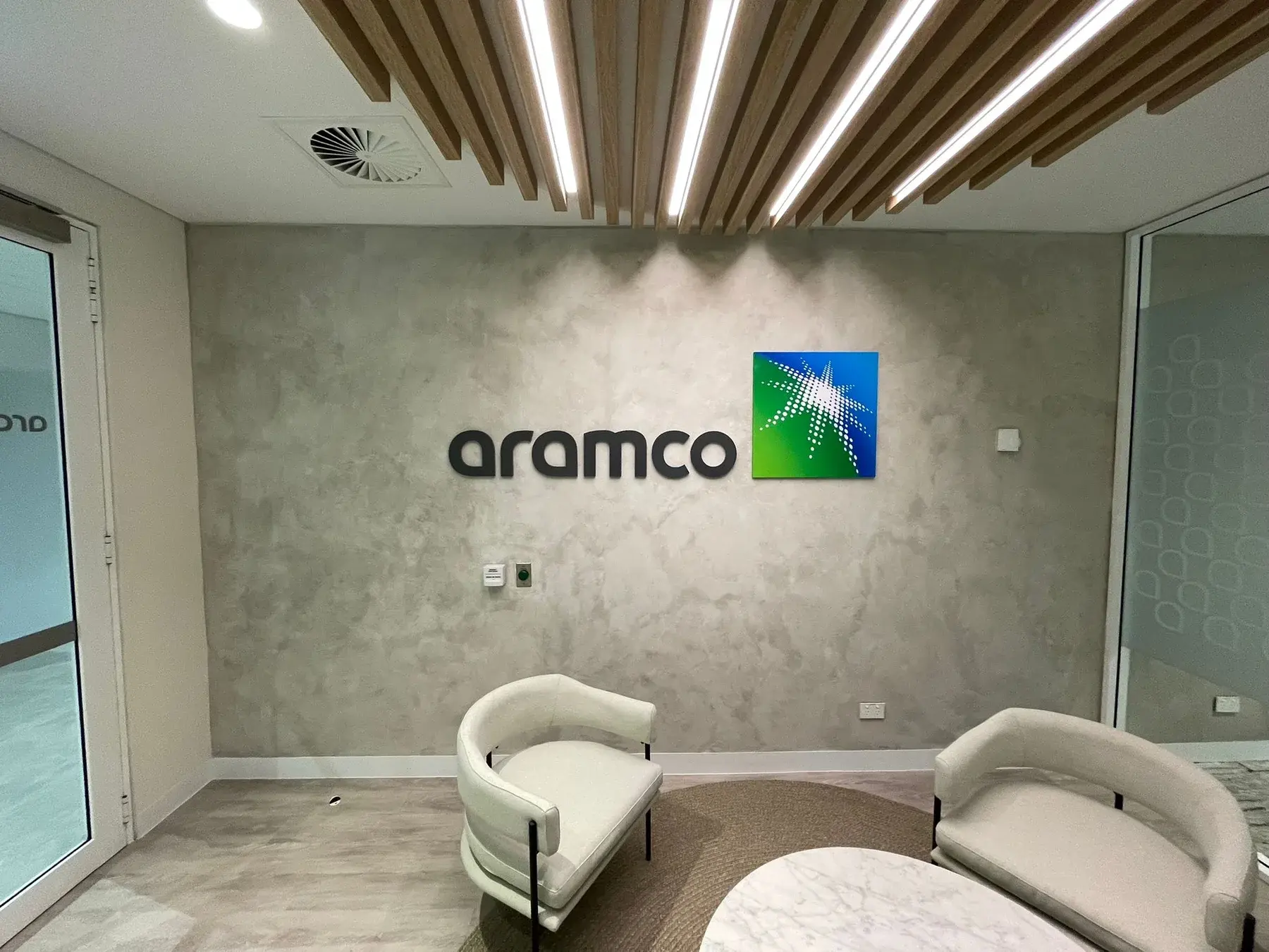 Painted non-illuminated metal Aramco 3D lettering installed in a Sydney CBD reception area