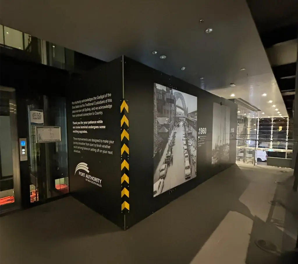 Interior hoarding corner carrying an Acknowledgement of Country and a passenger message about the terminal upgrade