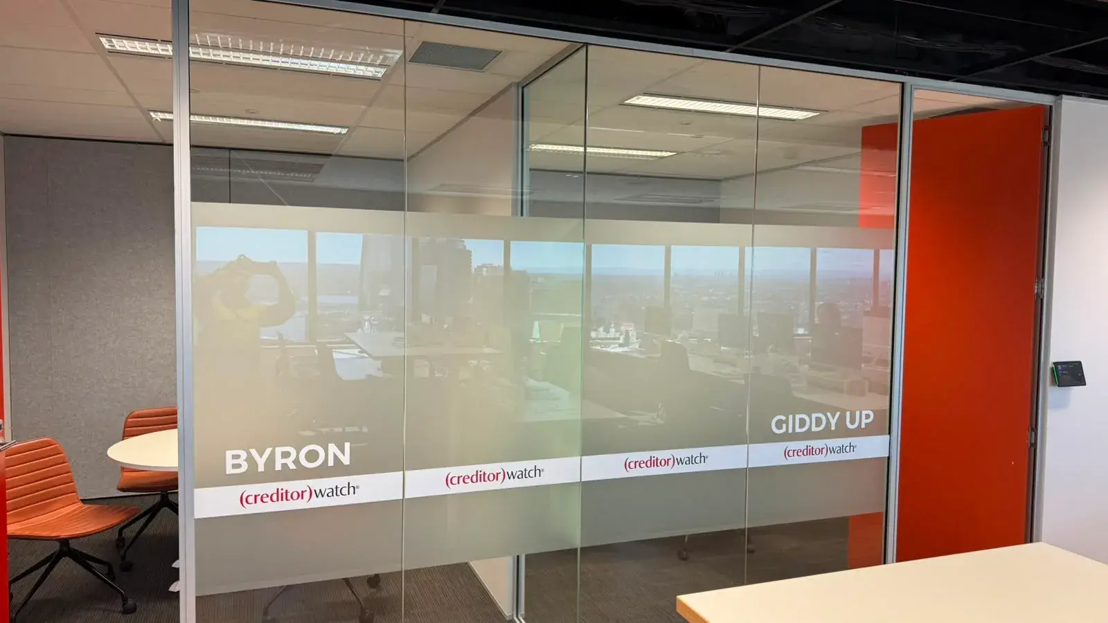 A long glass run for the Byron and Giddy Up rooms carrying a full printed frosted panel and repeated CreditorWatch branding