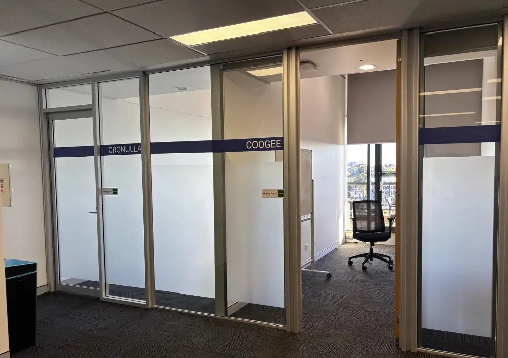 Two further glazed meeting rooms named Cronulla and Coogee with matching vinyl lettering on the partition band