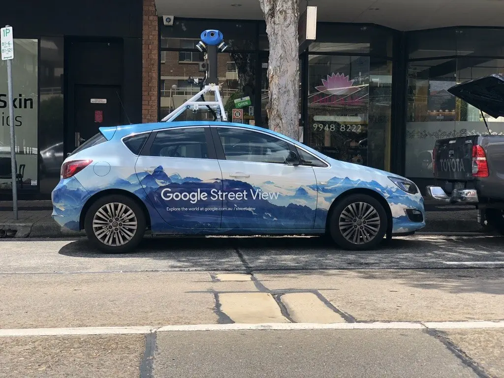 Wrapped Street View vehicle parked on a Sydney street with its roof camera rig mounted