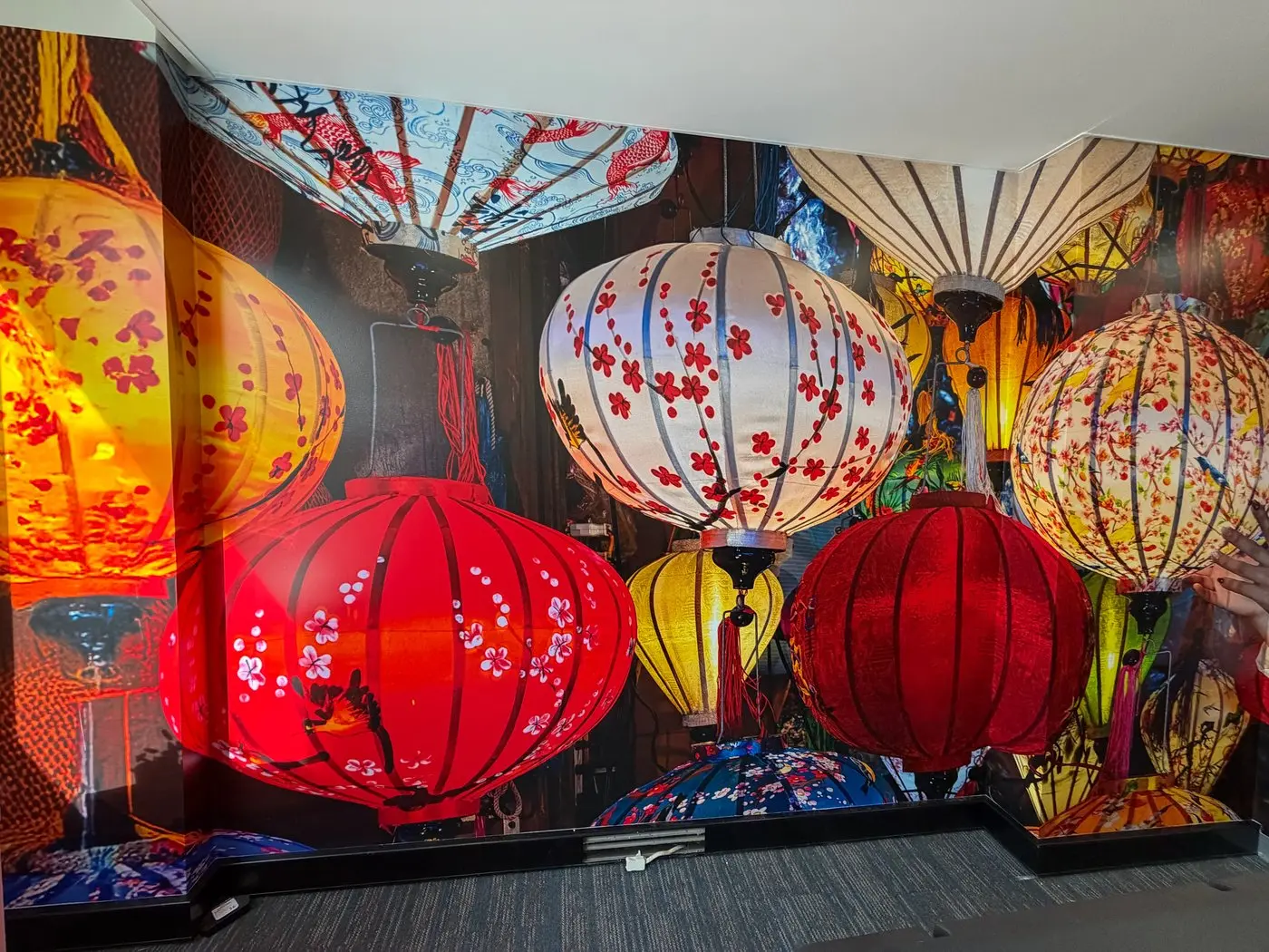 Vivid festival lantern wall mural wrapping around a corner of the Helloworld Travel office