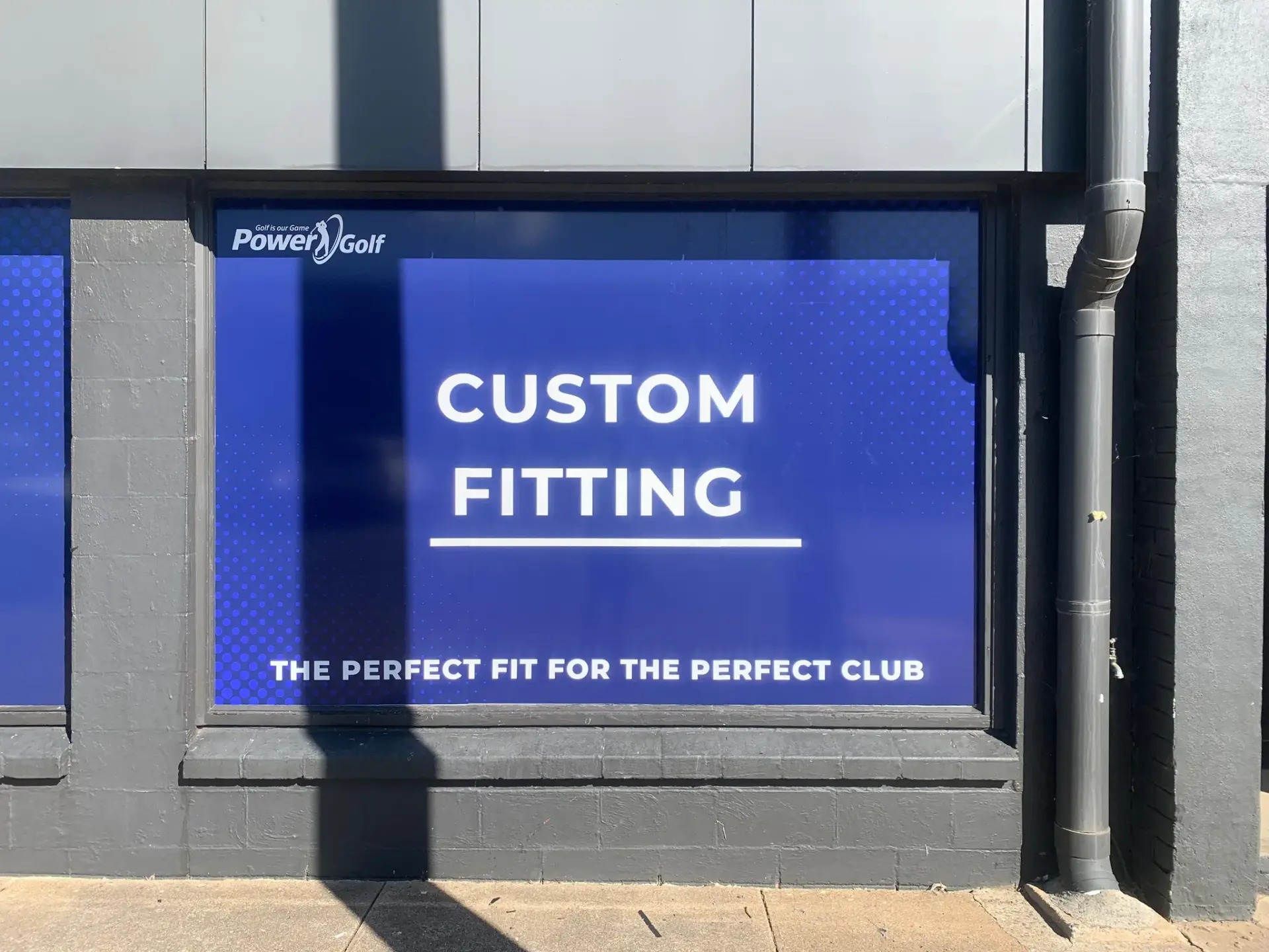 Custom Fitting service window graphic printed on the blue dotted Power Golf background