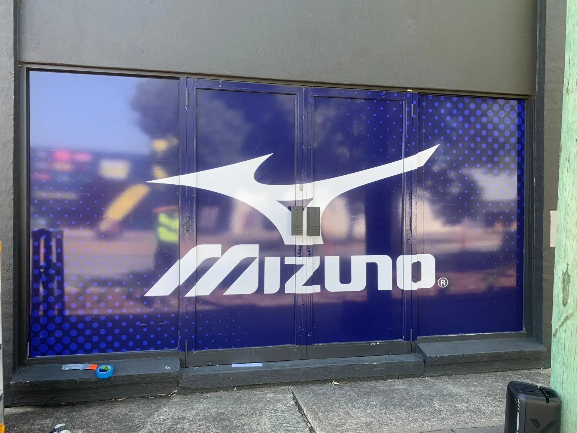 Mizuno window graphic applied across the full-height glazing on the street frontage
