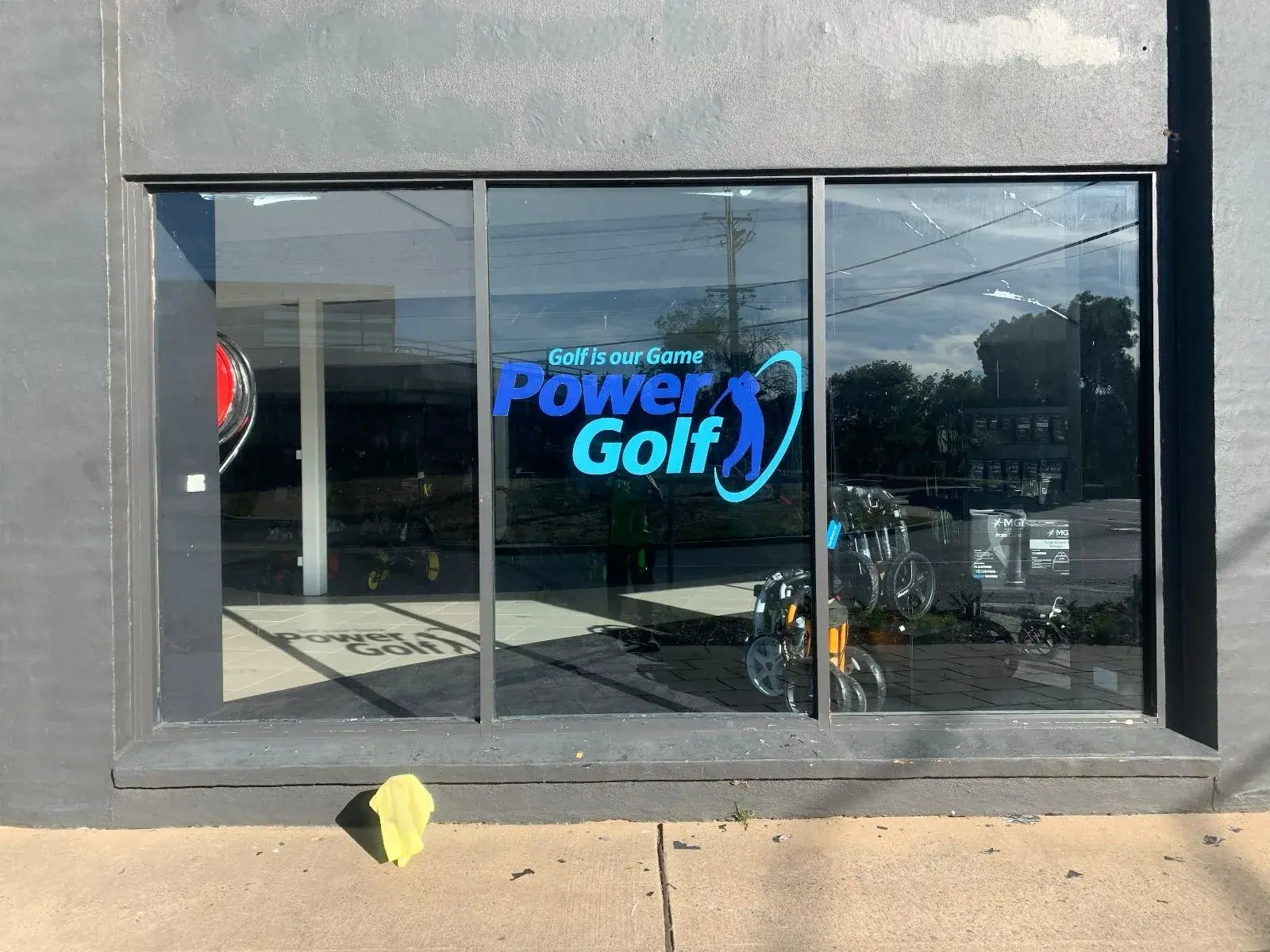 Power Golf cut vinyl logo applied to the glazing and read from inside the store