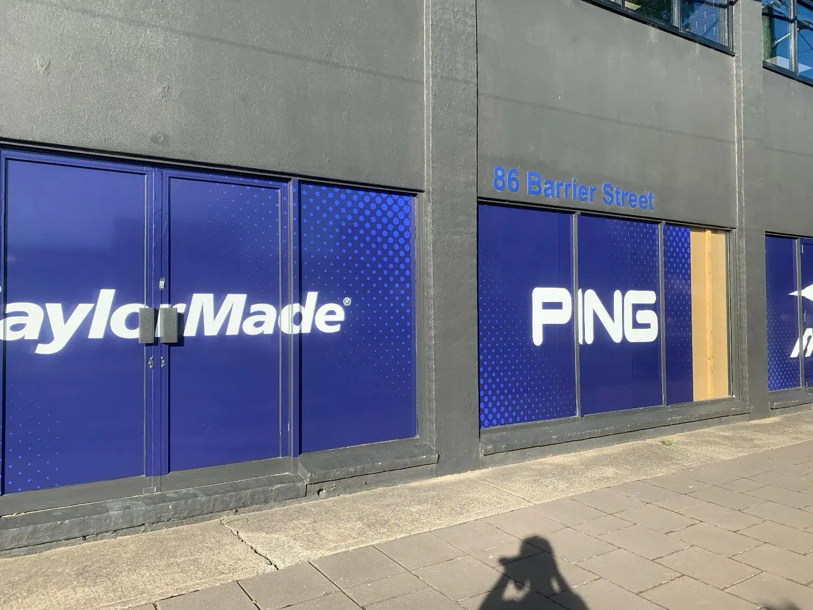 TaylorMade and PING window graphics running along the Fyshwick street frontage