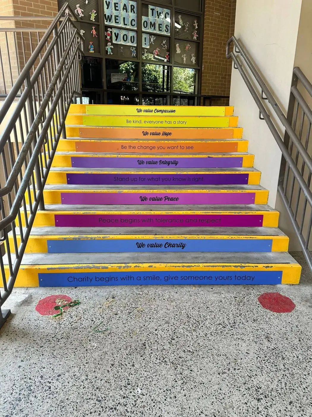 Staircase with each riser printed with a school value such as compassion, hope, integrity, pride and charity