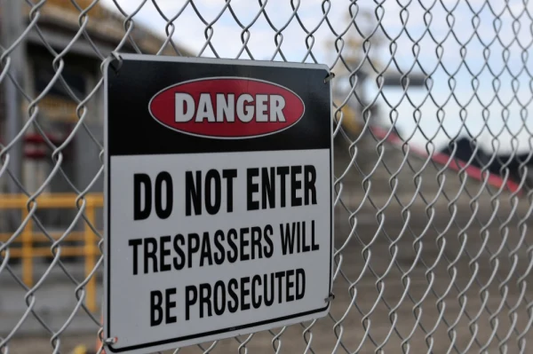 Danger sign mounted on a security fence