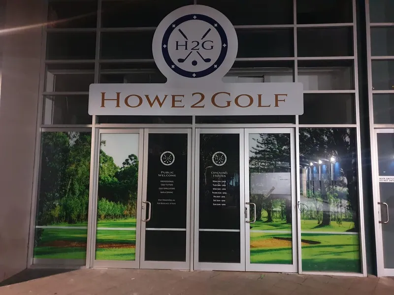 Howe2Golf entrance with a round logo, fascia lettering and printed glass panels.