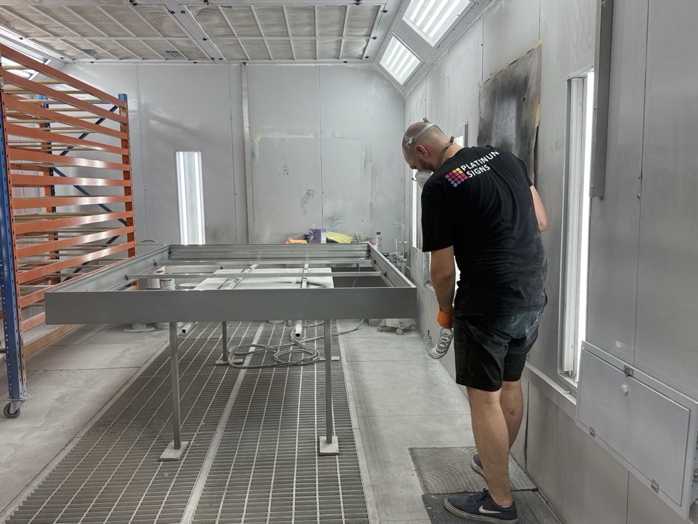 Two-pack spray painting a panel in a spray booth