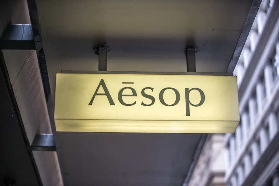 Illuminated opal acrylic lightbox sign mounted under an awning