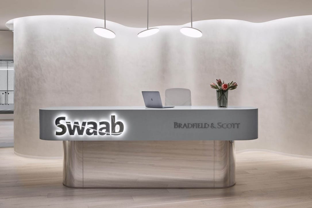 Swaab lettering across a sculpted reception counter
